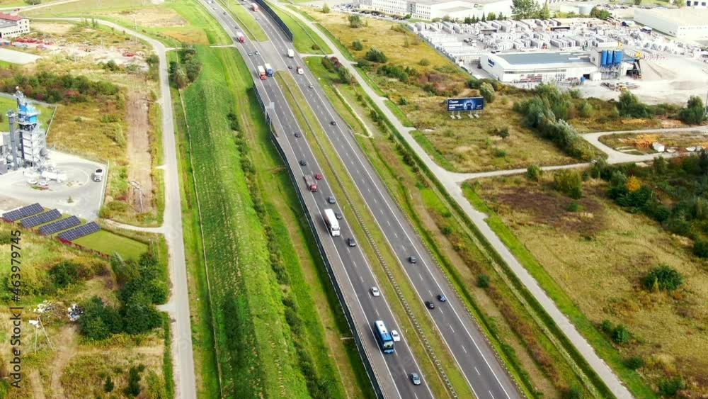 Big logistics terminal in countryside near highway, Delivery center traffic on the highway aerial shot Big logistics terminal in countryside near highway, Delivery center traffic on the highway aerial shot