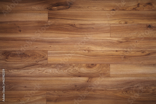 The Dark brown wooden surface parquet texture with light vignetting.