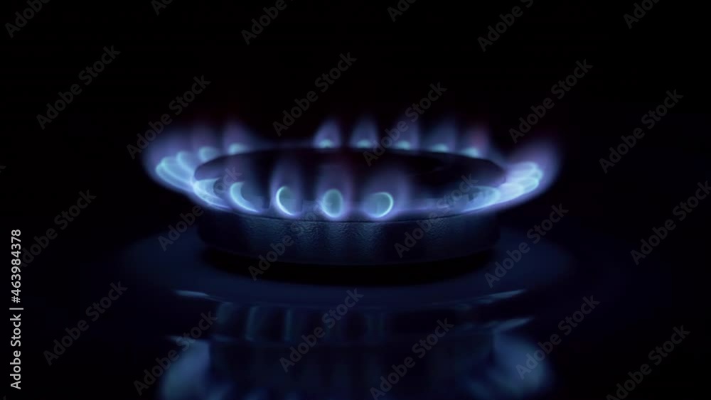 Gas burner turning off. Flames of natural gas burning from a gas stove in the dark. Gas burner turning off. Flames of natural gas burning from a gas stove in the dark.