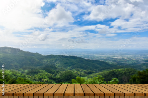 wooden table and beauty blur sky and mountains as background. © Anurak