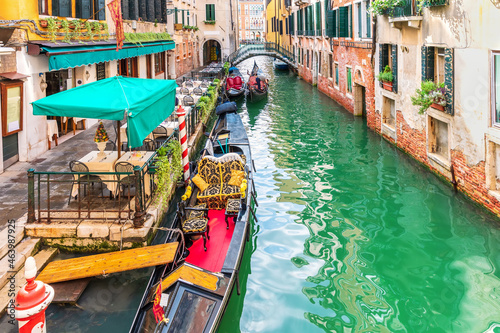 Gondola moored in a narrow street canal of Venice, Italy