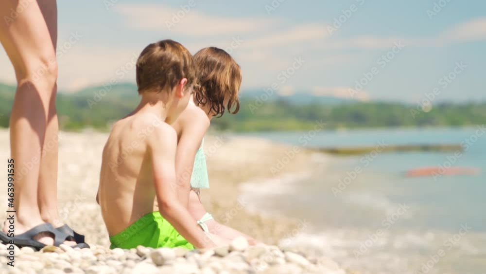 Mother applying sunblock cream on her son shoulder. Sun protection of childs skin. Healthcare consept Mother applying sunblock cream on her son shoulder. Sun protection of childs skin. Healthcare consept