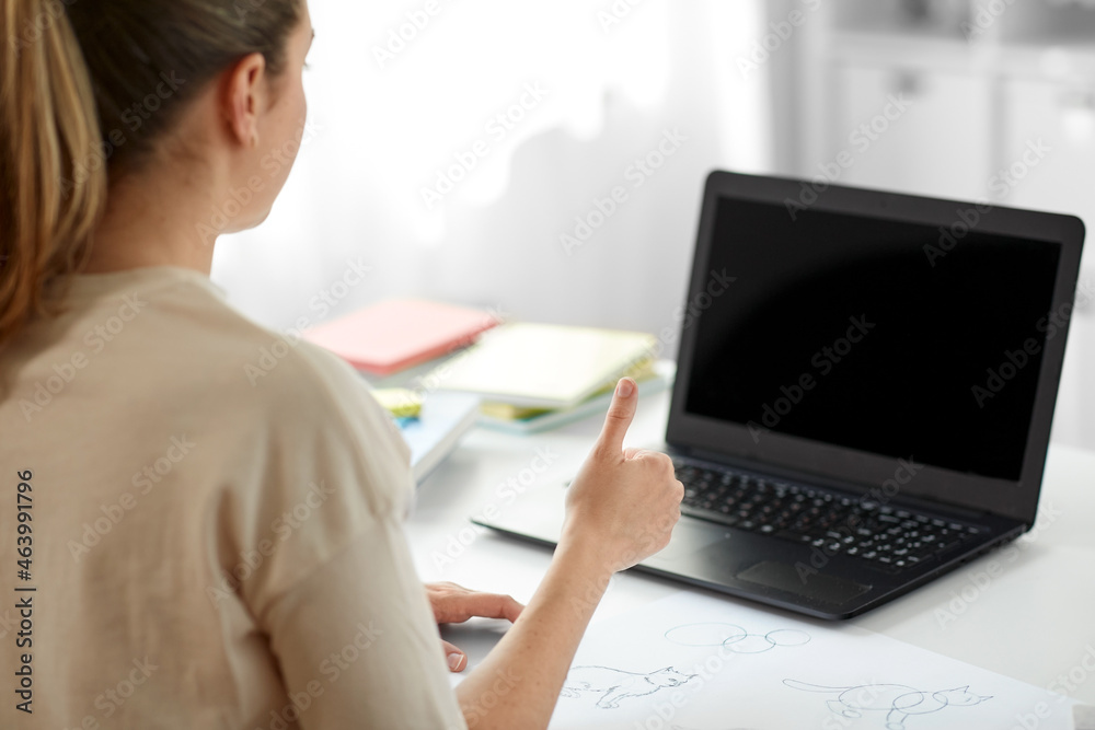 education, online school and distant learning concept - student woman with laptop computer and pencil drawing showing thumbs up at home education, online school and distant learning concept - student woman with laptop computer and pencil drawing showing thumbs up at home
