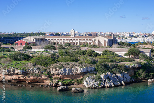 Fototapeta Naklejka Na Ścianę i Meble -  L'Illa del Rei Hospital Island in the middle of the main navigable entry channel to Mahon in Menorca in the Mediterranean Sea