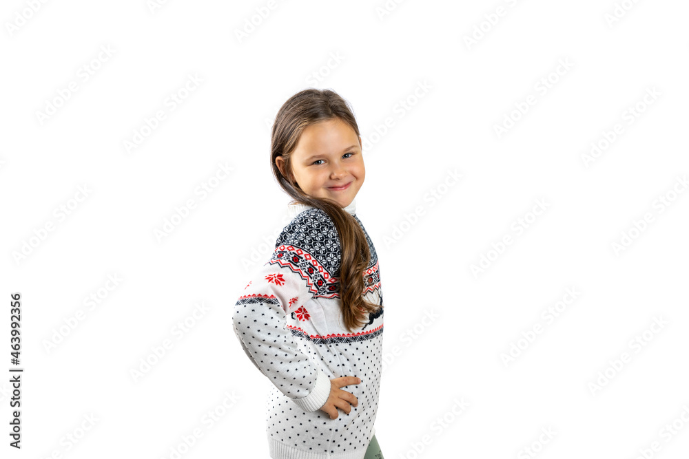 cute, six-year-old girl in white knitted Christmas sweater with reindeer poses with hand on waist, isolated on white background. cute, six-year-old girl in white knitted Christmas sweater with reindeer poses with hand on waist, isolated on white background.