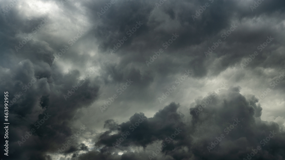 gray stormy dramatic sky with overcast and heavy textured cumulus clouds and backlight. large panoramic view gray stormy dramatic sky with overcast and heavy textured cumulus clouds and backlight. large panoramic view