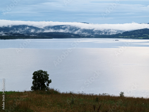 Fog over the lakeafter the storm, lake Lipno in the mountains Sumava, Czech Republic photo