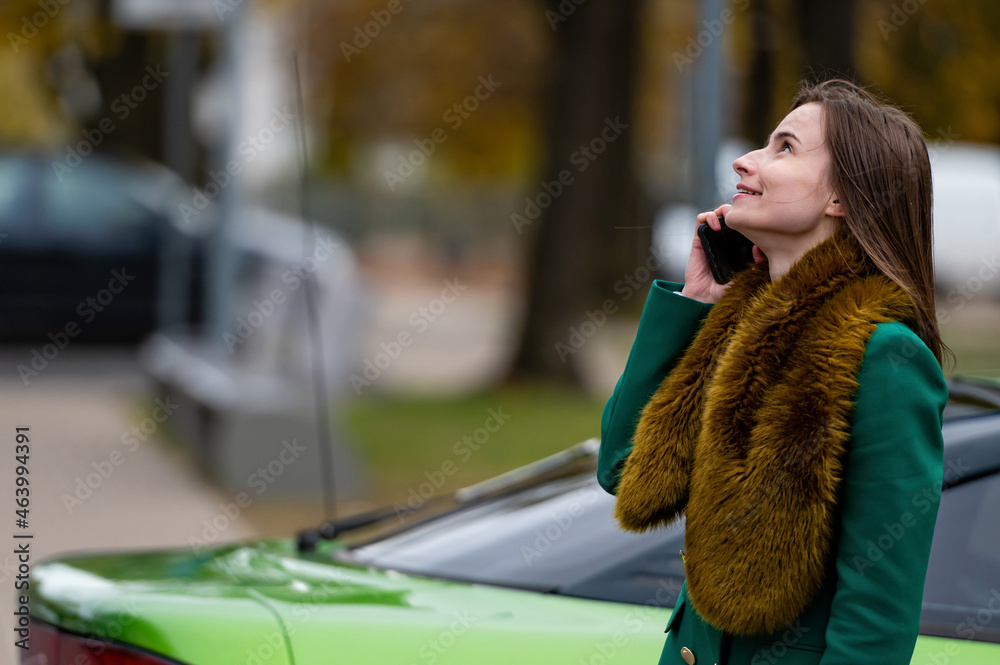 bussines woman using mobile phone, standing near car on street or parking bussines woman using mobile phone, standing near car on street or parking
