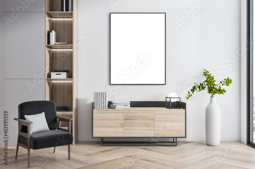 Fototapeta Naklejka Na Ścianę i Meble -  Modern interior with empty white mock up poster, wooden flooring, bookcase, armchair, decorative plant and window with city view. 3D Rendering.