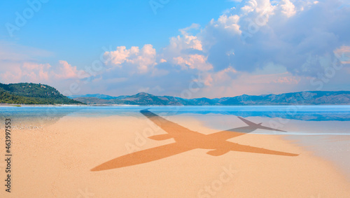 Passenger airplane shadow concept - Travel to exotic destination and airplane flying above beautiful tropical beach and sunny day