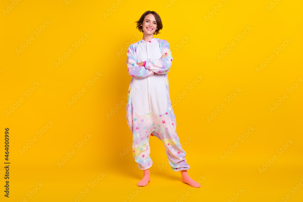Full length body size photo girl in unicorn costume crossed hands isolated vibrant yellow color background Full length body size photo girl in unicorn costume crossed hands isolated vibrant yellow color background