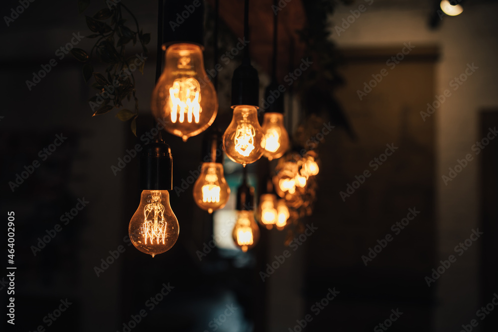 Lamp bulbs hanging on a dark background.