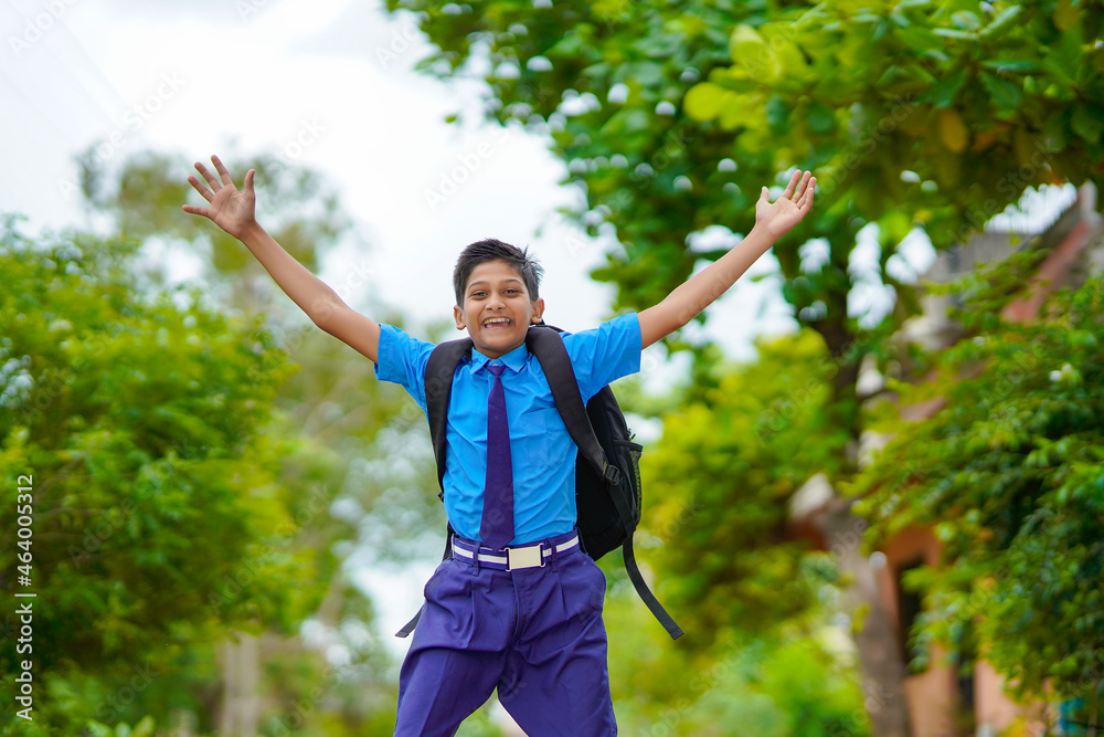 Excited school boy running and jumping on street after school. Excited school boy running and jumping on street after school.
