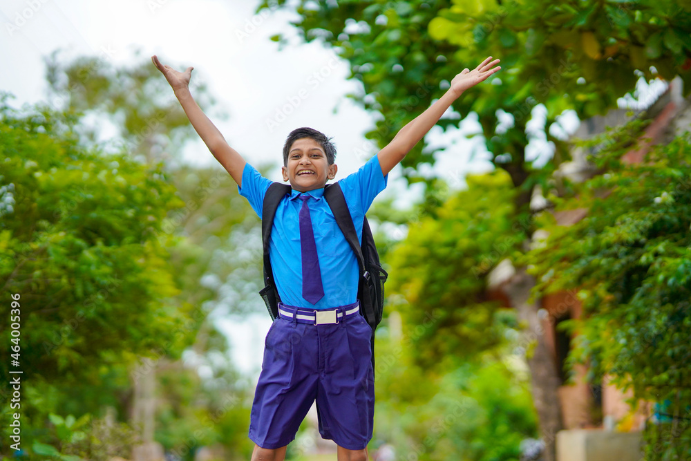 Excited school boy running and jumping on street after school. Excited school boy running and jumping on street after school.