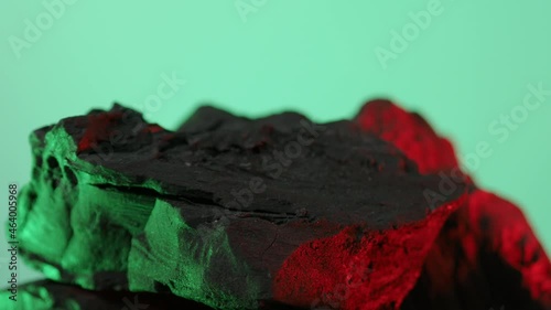 Wood charcoal. Black Charcoal on Blue green screen background. Used for cooking grill or industries. Natural wood charcoal. Black carbon reesidue produced by strongly heating wood. for grilled BBQ. 