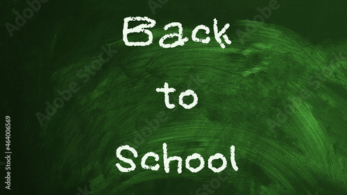 Back to school written on green chalkboard