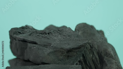 Wood charcoal. Black Charcoal on Blue green screen background. Used for cooking grill or industries. Natural wood charcoal. Black carbon reesidue produced by strongly heating wood. for grilled BBQ. 