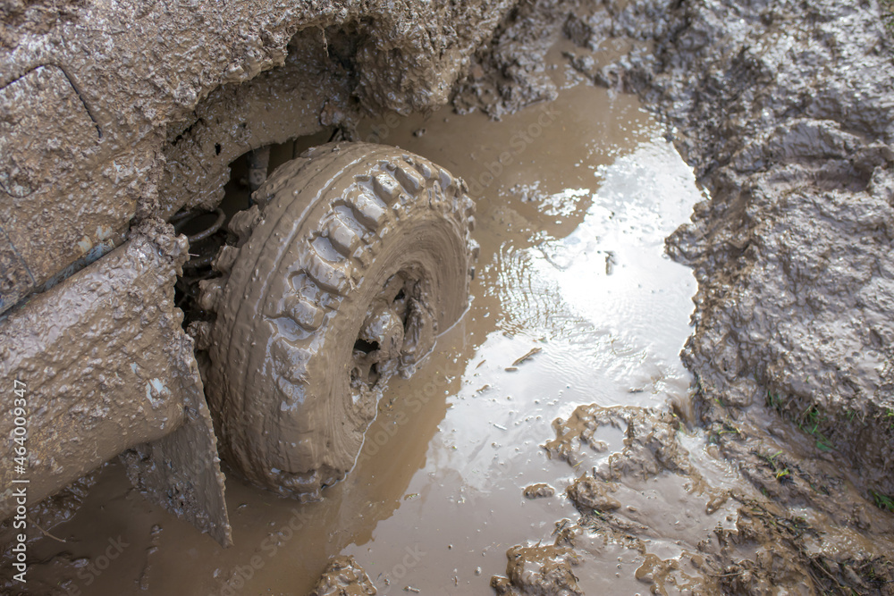 Car wheel stuck in mud, motorsport, mud tire testing. Offroad driving