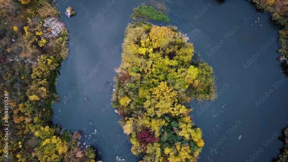 Aerial cinematic view of colorful autumn trees and blue river. drone shot. Aerial cinematic view of colorful autumn trees and blue river. drone shot.