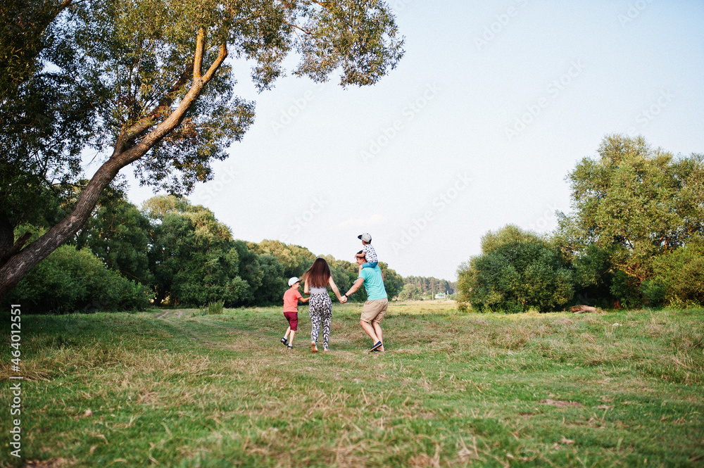 Happy young family: mother, father, two children son on nature having fun. Happy young family: mother, father, two children son on nature having fun.