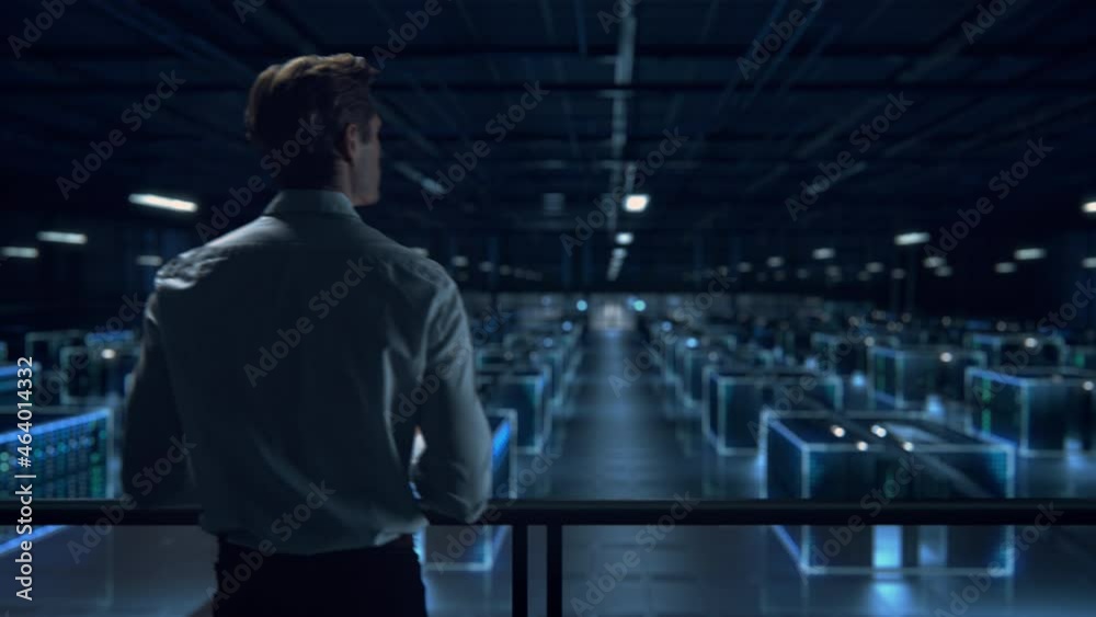 Successful Data Center IT Specialist Using Tablet Computer. Turning Augmented VFX Visualization on Server Farm Cloud Computing Facility. System Engineer Working for Cyber Data Security Company.