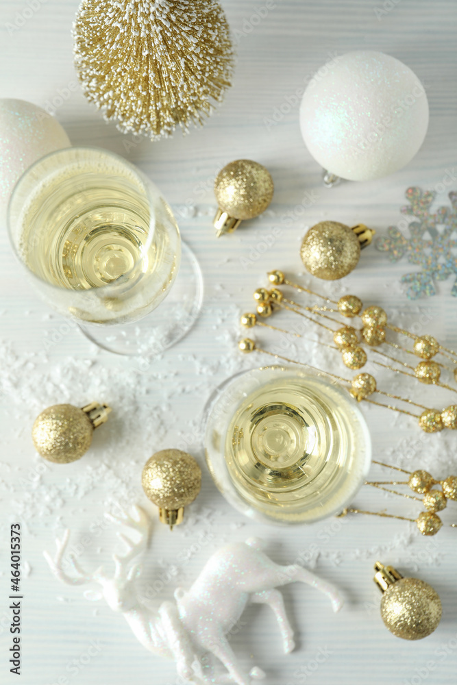 Concept of New Year celebration with champagne on white wooden background