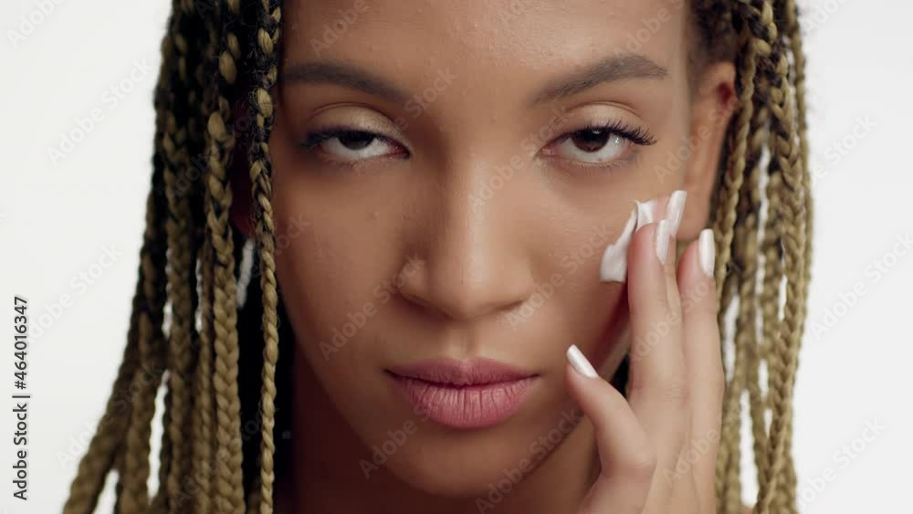 Portrait Of Black Lady Applying Cream Moisturizing Skin, White Background Portrait Of Black Lady Applying Cream Moisturizing Skin, White Background