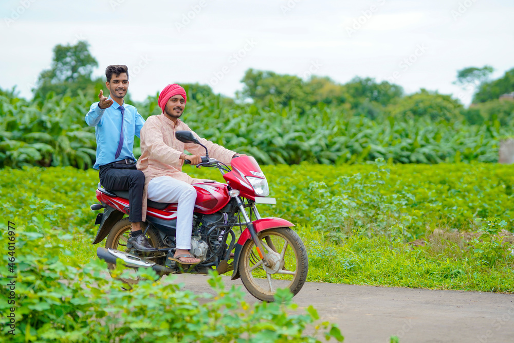 Indian agronomist going agriculture field with farmer on bike. Indian agronomist going agriculture field with farmer on bike.