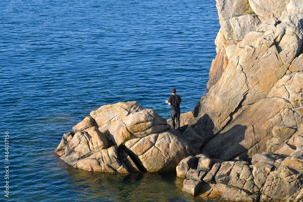Fototapeta premium Fisherman in the rock at seaside