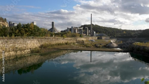 Abandoned Dutch Cement industry factory at chalk and limestone quarry in Limburg, the Netherlands with beautiful colored lake photo