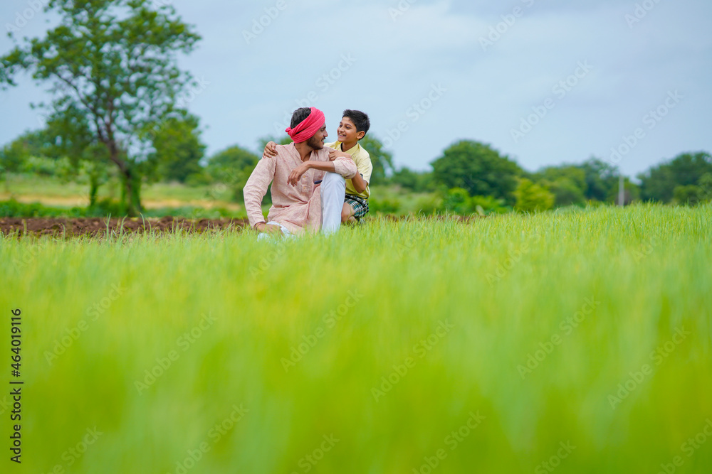 Indian farmer with his son at agriculture field. Indian farmer with his son at agriculture field.
