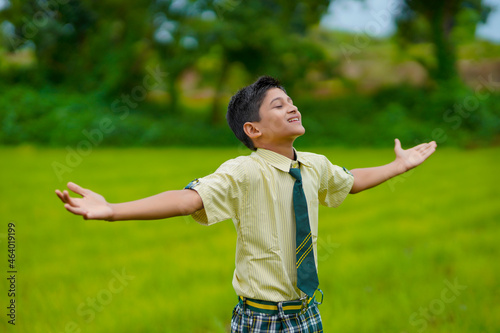 cute indian little school boy enjoying nature