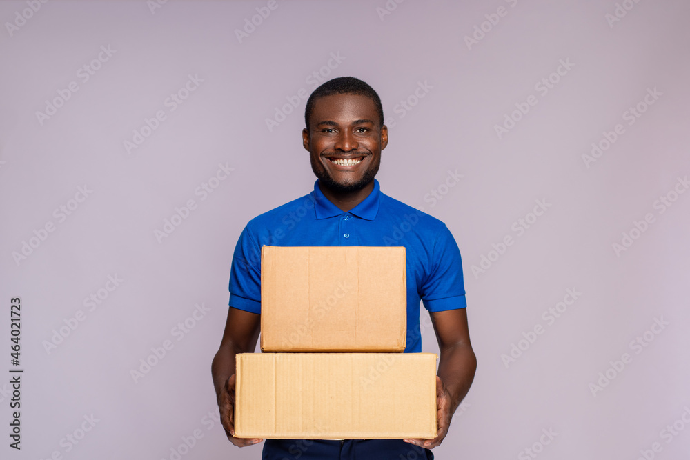 portrait of a black delivery worker holding some packages portrait of a black delivery worker holding some packages