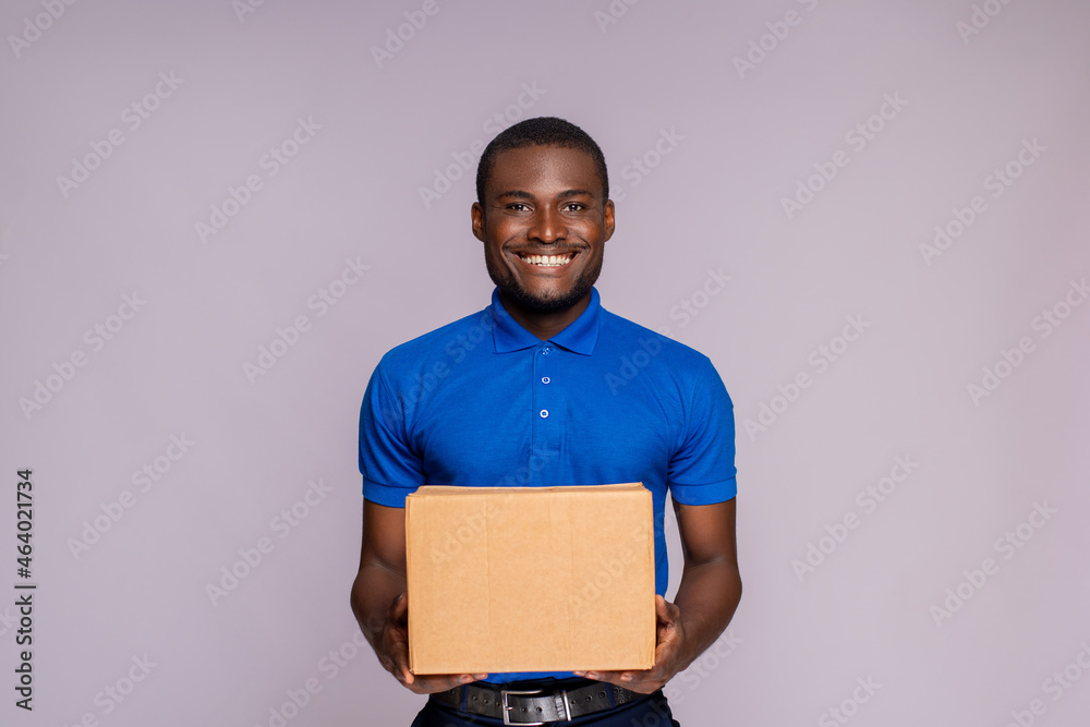 portrait of a black delivery worker holding a package portrait of a black delivery worker holding a package