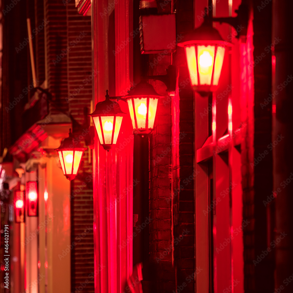 Background - Red light district in Amsterdam at night.  Selective focus on one lamp and defocus the rest. Amsterdam, Holland, Europe - obrazy, fototapety, plakaty 