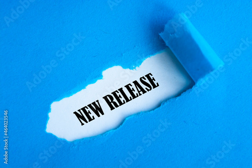 NEW RELEASE word under torn blue paper.