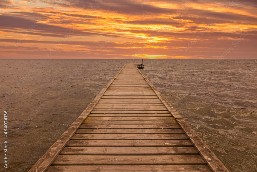 Wooden jetty at the Danish Baltic Sea coast in sunset