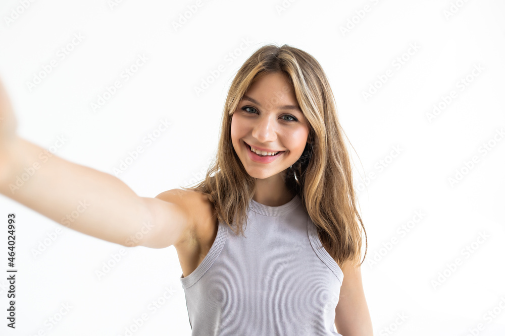 Young beautiful woman taking selfie. Isolated white background Young beautiful woman taking selfie. Isolated white background
