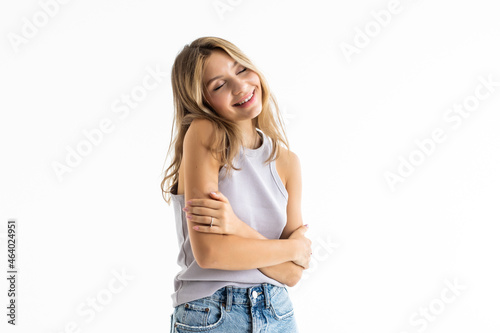 Portrait of happy woman standing with arms folded isolated on a white background