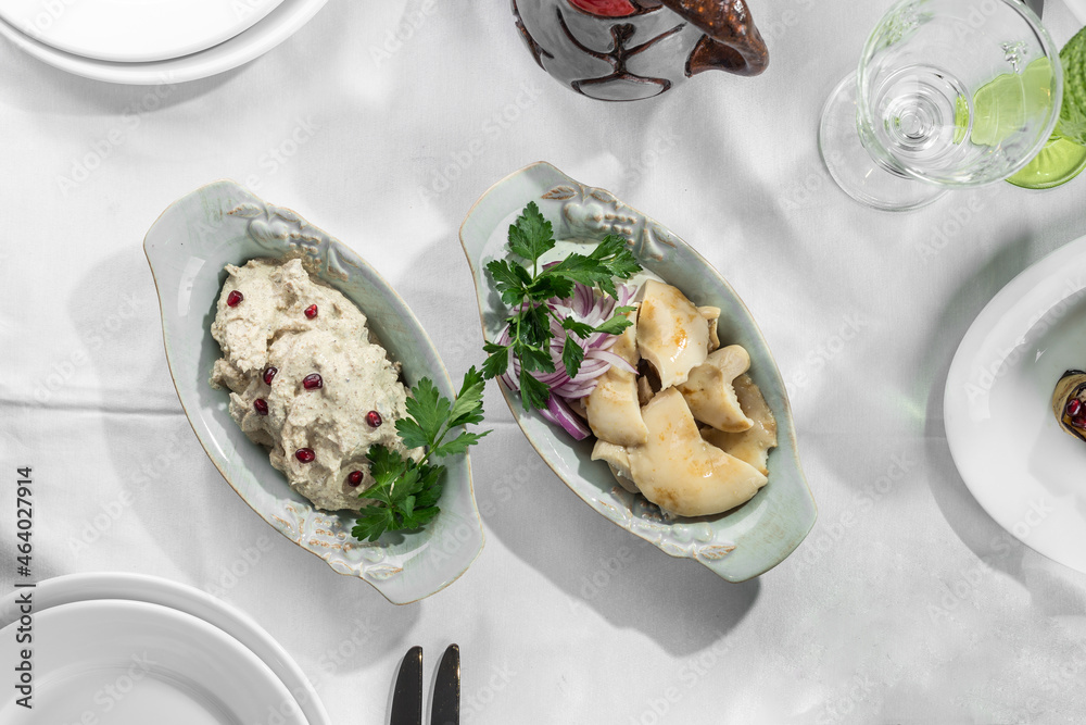 Pickled milk mushrooms with sour cream and chicken salad on the table Pickled milk mushrooms with sour cream and chicken salad on the table