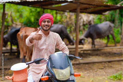 Rural scene : Indian milkman showing thumps up