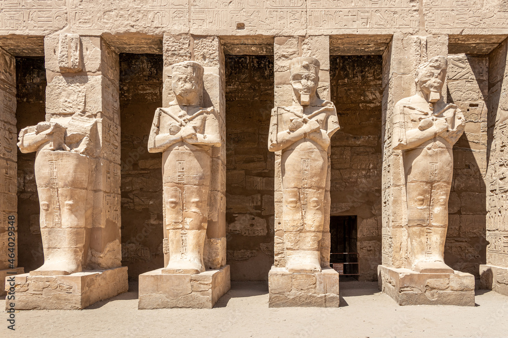 The statues of Pharaoh Ramses III as Osiris guarding the precinct of the temple of Karnak, Luxor, Egypt.