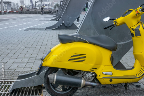 Yellow Scooter at an Iron Support