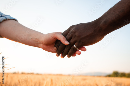 Multiracial relationship and friendsip concept. Two hands holding together.