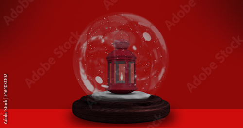 Image of red lantern in snow globe over red background