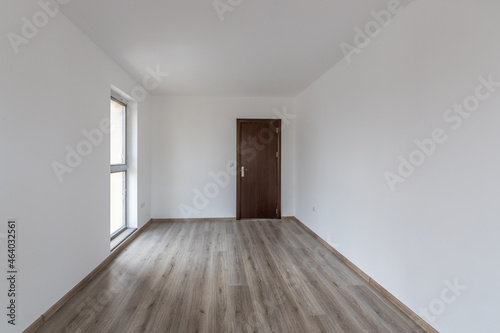 Empty room with natural light from windows.Modern house interior. New home. Wooden floor.