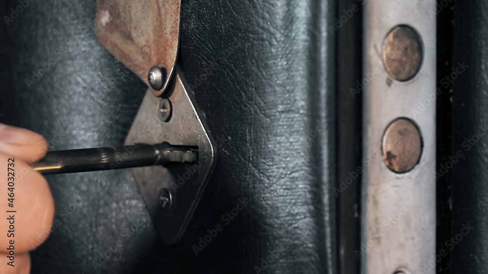 Closing the door with a key.Hand holding brass key and opens lock door.Black door. The key is inserted into the keyhole.Security of the house.The hand turns the key. Closing the door with a key.Hand holding brass key and opens lock door.Black door. The key is inserted into the keyhole.Security of the house.The hand turns the key.