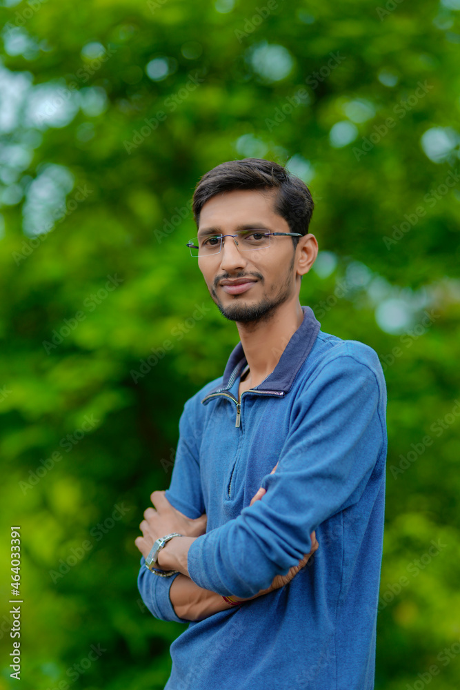 Young indian man showing expression over nature background. Young indian man showing expression over nature background.