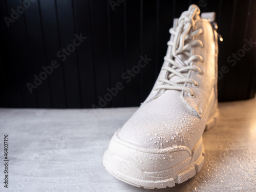 Water droplets on winter shoe protected with waterproof spray 