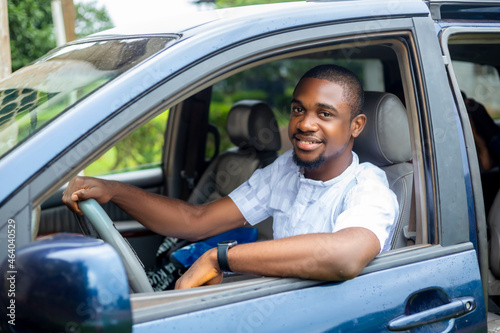 Portrait of a young black african handsome driver in taxi car photo